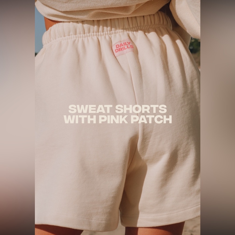 Daily Drills Sweat Shorts in Sand with Pink Patch